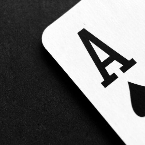 ace of spade playing card on grey surface